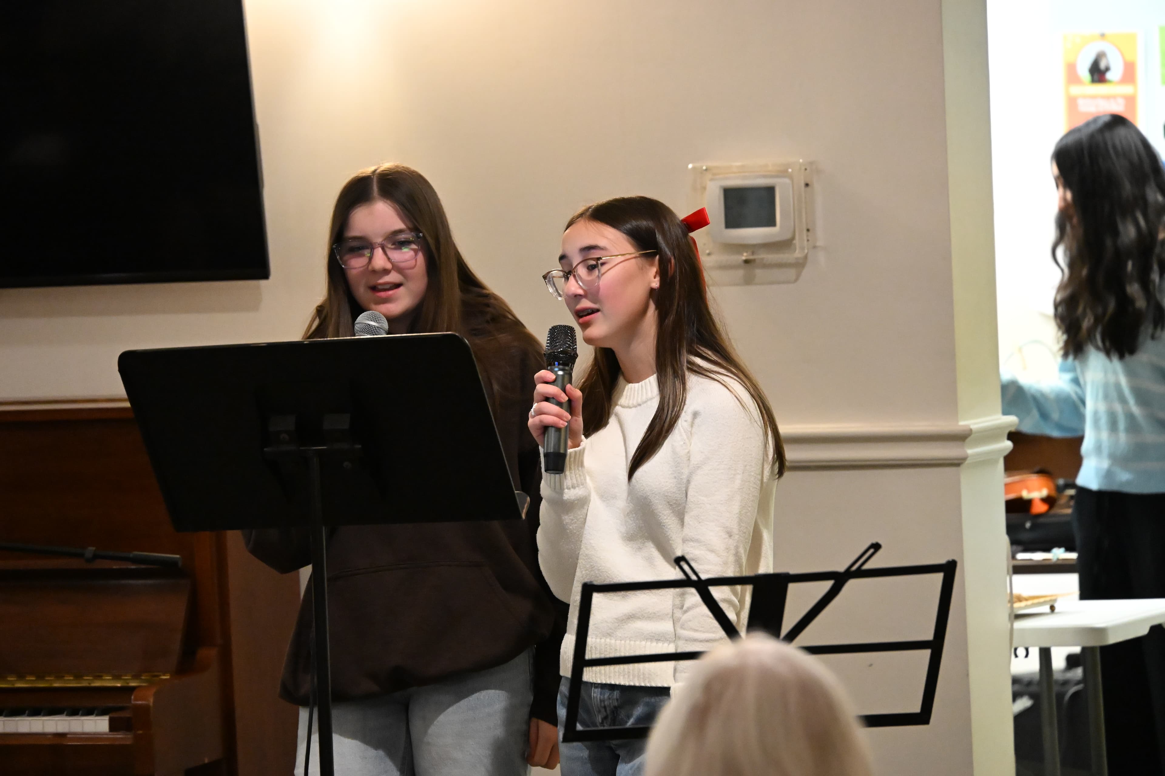 /assets/alex-emily-singing-holiday-concert.JPG