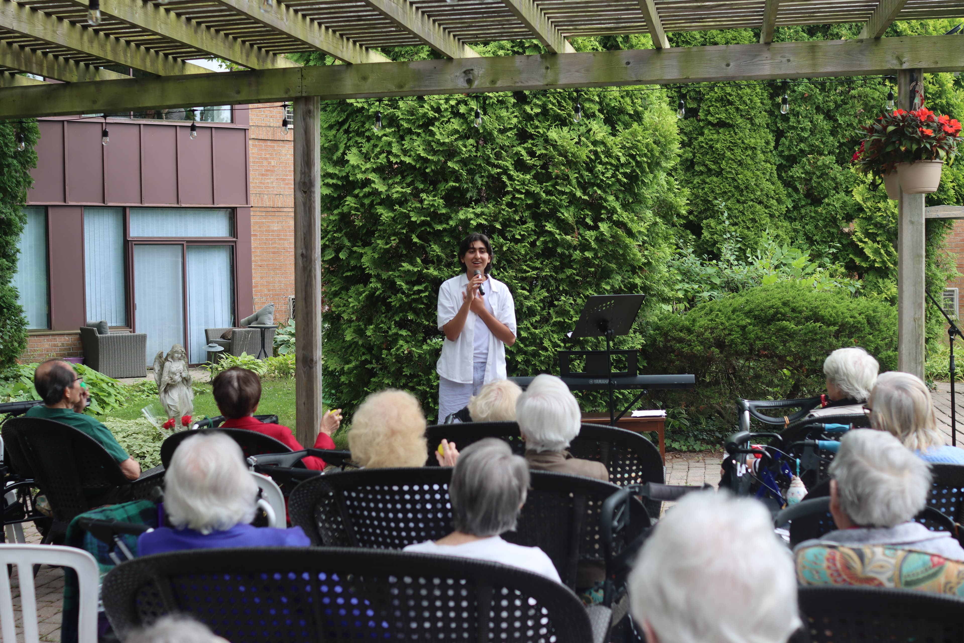 /assets/ishaan-singing-many-seniors.JPG