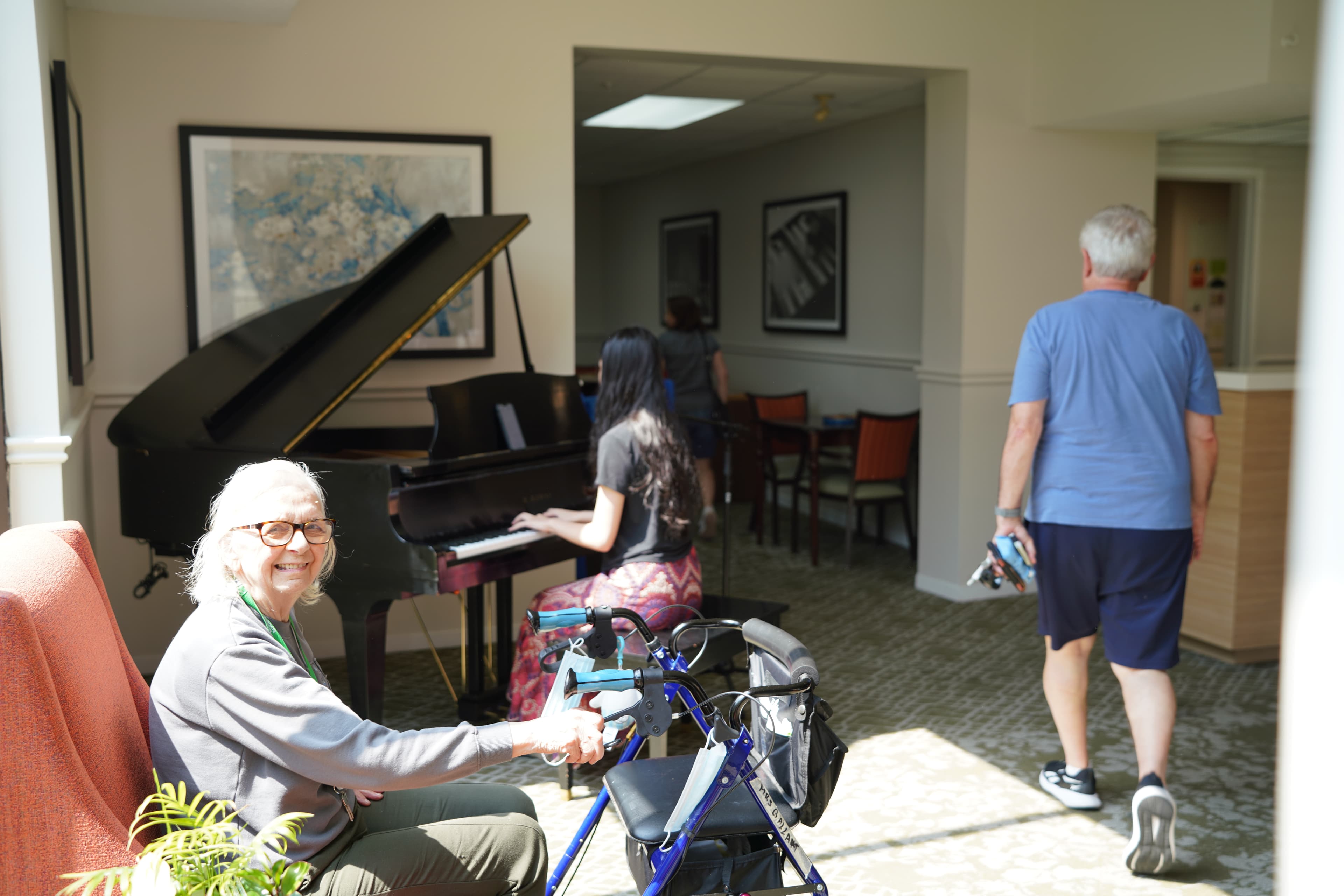 Young performer playing piano for seniors